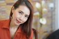 BeautifulÃ¢â¬â¹ womanÃ¢â¬â¹ inÃ¢â¬â¹ orangeÃ¢â¬â¹ dressÃ¢â¬â¹ posing in the room Royalty Free Stock Photo